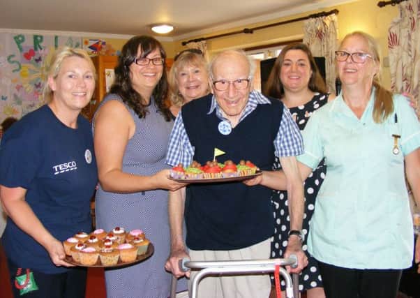 Celebrating Cupcake Day for the Alzheimer's Society and National Care Home Open Day, from left Tesco community volunteer Lesley Sargeant, Ashdene Care Home manager Jilly Hunt, activity volunteer Susanne Williams, resident Hugh Burbidge celebrating his 99th birthday, singer Tina Wynters and care home staff member Dorinda Hawkins. EMN-170616-155323001