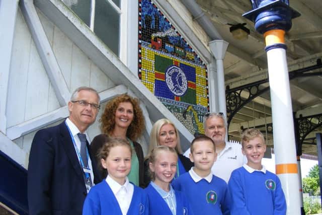 Unveiling their new footbridge mosaic at Sleaford rail station. Children from Ancaster School's Class Jamaica with, from left - Clive Yates of East Midlands Trains, local artist Louise Hill, Community Rail Partnership Officer Kay Robinson and Sustrans Schools Officer Jon Moody. EMN-170613-170218001