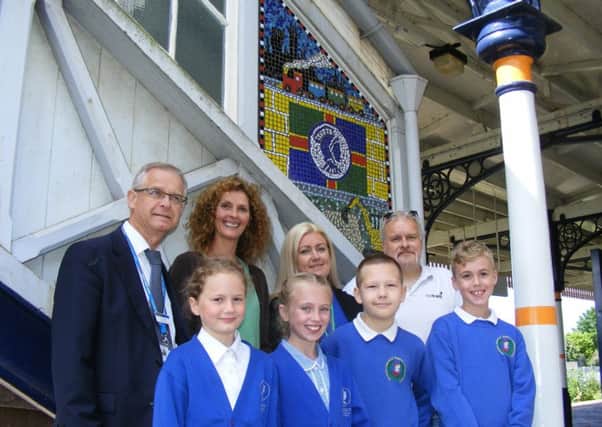 Unveiling their new footbridge mosaic at Sleaford rail station. Children from Ancaster School's Class Jamaica with, from left - Clive Yates of East Midlands Trains, local artist Louise Hill, Community Rail Partnership Officer Kay Robinson and Sustrans Schools Officer Jon Moody. EMN-170613-170218001
