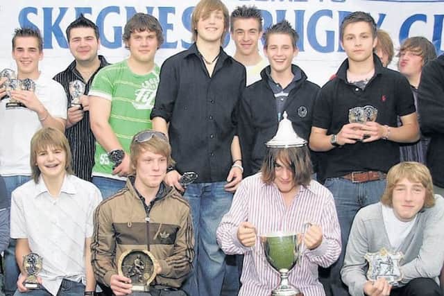 Some members of the junior rugby under 15 team receiving trophies at the presentation night 10 years ago.