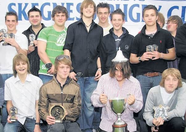 Some members of the junior rugby under 15 team receiving trophies at the presentation night 10 years ago.