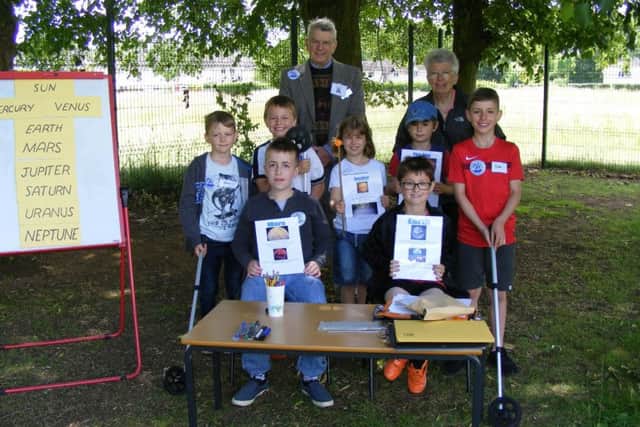 David and Janine Pike from the Royal Institute of Navigation show Cranwell children how to map out the Solar System using trundle wheels and rubber balls on sticks, at Cranwell School Experience Day. EMN-170620-093431001