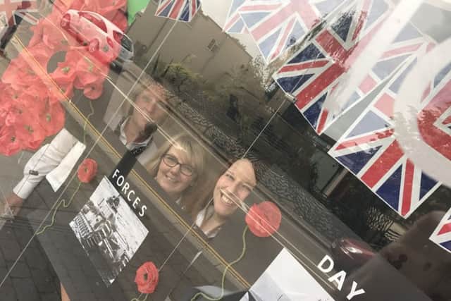 Staff at Lunettes opticians in their Armed Forces Day window display. EMN-170620-114741001