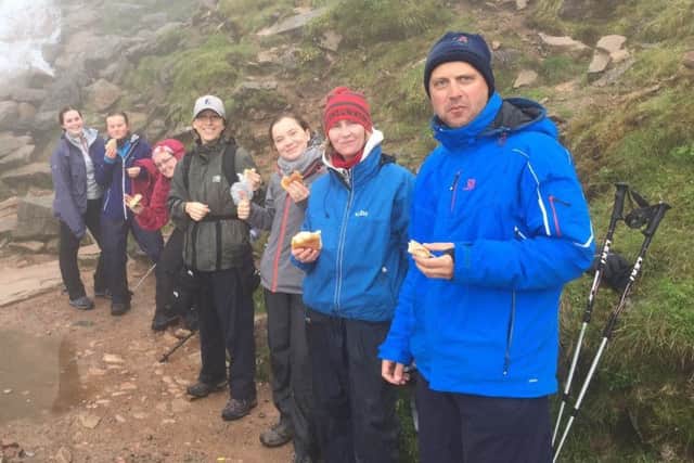 Tuck in... The team pictured halfway up the mountain by the waterfall enjoying a snack.