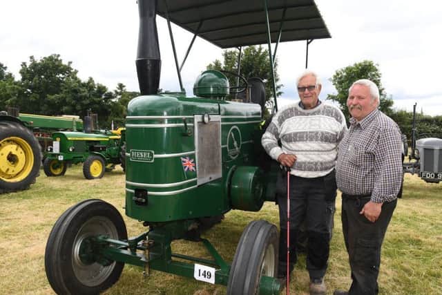 Swaton Vintage Day and World Egg Throwing Championships. L-R Rod Gilbert of Billinghay and David Wakefield looking at Rod's 1950 Field Marshall series 3. EMN-170626-131740001