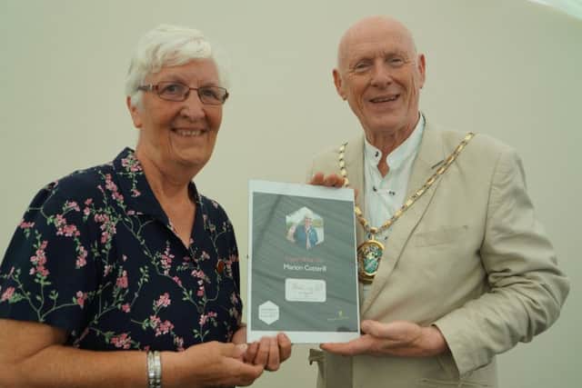 Lincolnshire County Council Vice Chairman Ron Oxby presenting a Good Citizens Award to Marion Cotterrill, of Skegness. ANL-170622-092213001