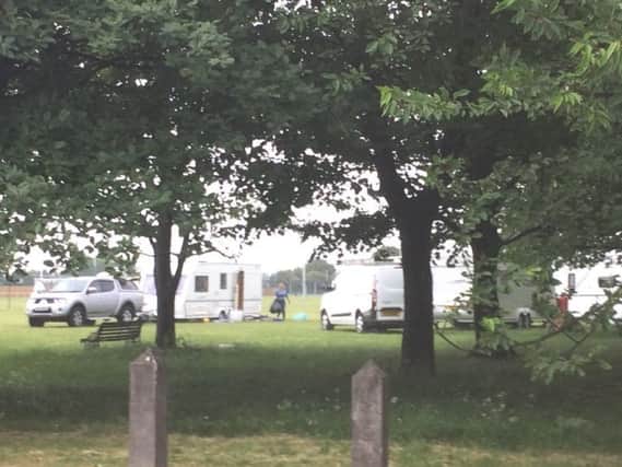 Travellers clearing up after a police operation where two stolen caravans were seized from a site in Skegness.