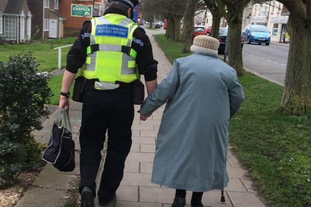 The picture featuring PCSO Dave Bunker helping an elderly lady who had lost her way in Skegness which hit the national headlines. ANL-170623-170447001