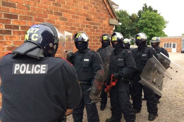 Police in riot gear at Billingborough on Friday. EMN-170626-100934001