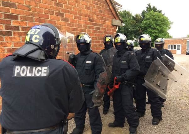 Police in riot gear at Billingborough on Friday. EMN-170626-100934001