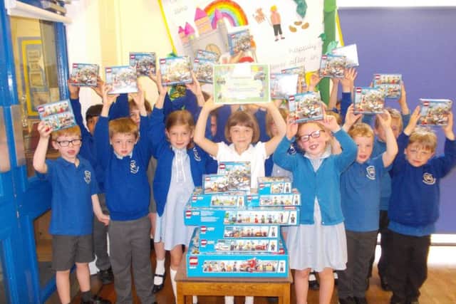 Amy Lewis and her friends at Winchelsea Primary School with the Lego sets she has won for them. EMN-170627-103302001