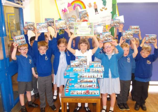 Amy Lewis and her friends at Winchelsea Primary School with the Lego sets she has won for them. EMN-170627-103302001