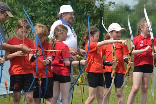 Pupils trying archery. EMN-170407-101947001