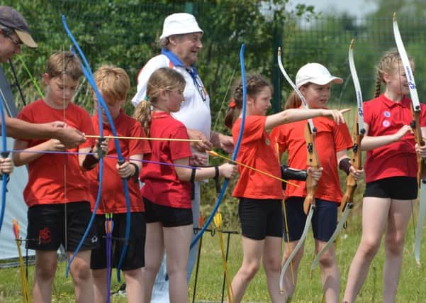 Pupils trying archery. EMN-170407-101947001