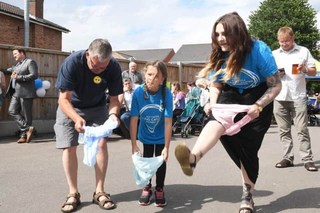 Family Fun Day at Red Lion, Ruskington, in aid of Roy Castle Lung Cancer Foundation. L-R Stewart Long, Molly Harlow 10 and Famienne Eeles having a go at the Red Lion Recod Breakers, knicker challenge. EMN-170629-173931001