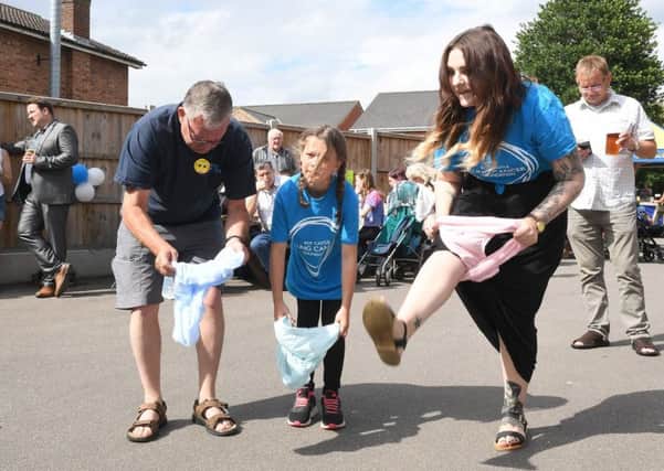 Family Fun Day at Red Lion, Ruskington, in aid of Roy Castle Lung Cancer Foundation. L-R Stewart Long, Molly Harlow 10 and Famienne Eeles having a go at the Red Lion Recod Breakers, knicker challenge. EMN-170629-173931001
