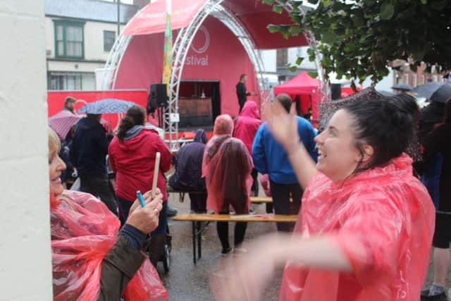 Katie-Louise Green, SO Festival co-ordinator for Magna Vitae, showing how to brave the rain during a Live broadcast with the Skegness Standard. ANL-170628-115606001