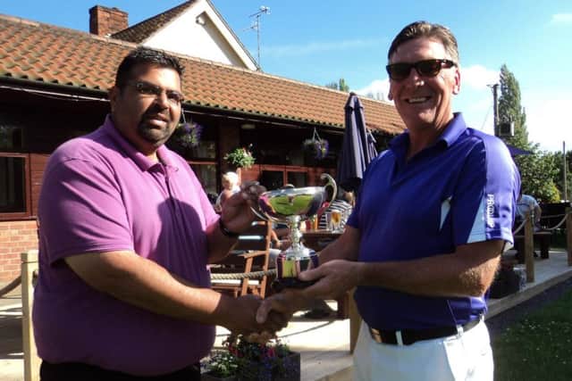 Indy Mattu (left) receives the Captains Cup from Gaff Elliott EMN-170307-100400002
