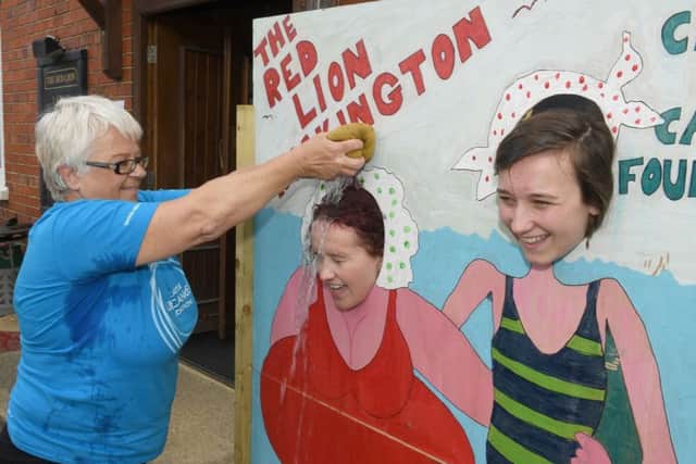 Family Fun Day at Red Lion, Ruskington, in aid of Roy Castle Lung Cancer Foundation. Sharon Hardwick soaking L-R Steph Battersby and Amy Clarke. EMN-170629-173959001