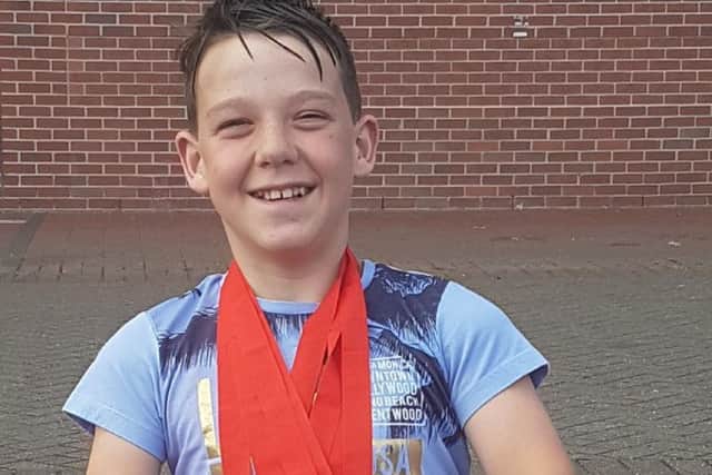 Harvey proudly shows off his national medal haul EMN-170629-174935002