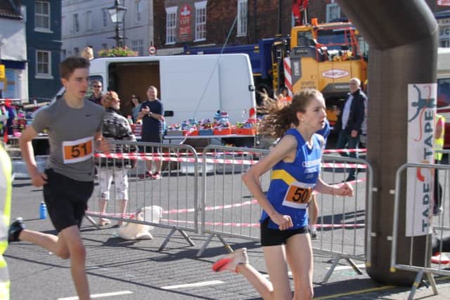 Brother and sister Grace and Oliver Sullivan 1st and 2nd in the fun
run cross the finishing line. EMN-170207-222642001