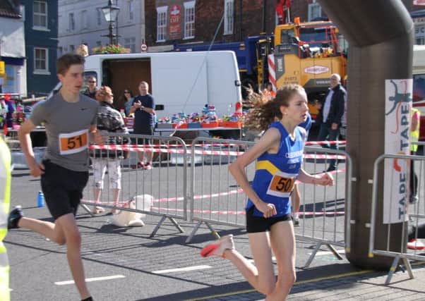 Brother and sister Grace and Oliver Sullivan 1st and 2nd in the fun
run cross the finishing line. EMN-170207-222642001