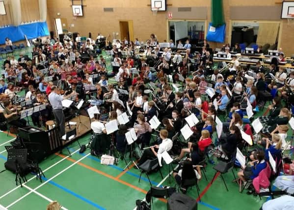 The giant youth orchestra formed for the music day at Carre's Grammar School. EMN-170707-170319001