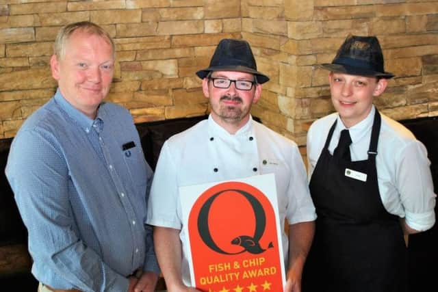 Celebrating, from left - Elite Fish Chip Company owner Adrian Tweedale, fryer manager Matt Case and server Emma Hyde at the Sleaford restaurant. EMN-170607-092859001