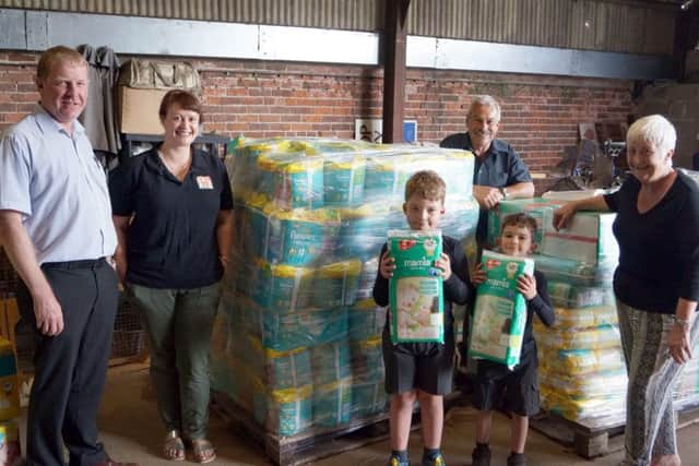Geoff Hill and the Hammond family with just some of the donations ready to be transported EMN-171107-080304001