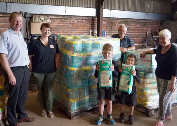 Geoff Hill and the Hammond family with just some of the donations ready to be transported EMN-171107-080304001