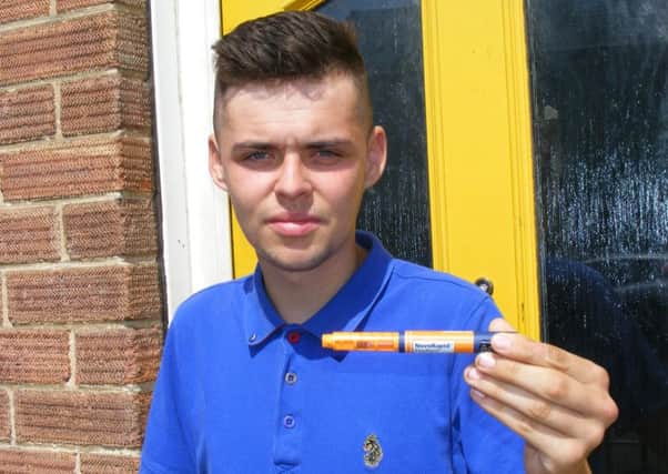 Ryan Paterson of Sleaford and one of the insulin injection pens he vitally needs to keep his diabetes under control.