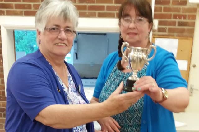 Norma Booth, WI Advisor, presenting the Kemp Cup for the most points in show to Keitha Eames. EMN-170713-155320001