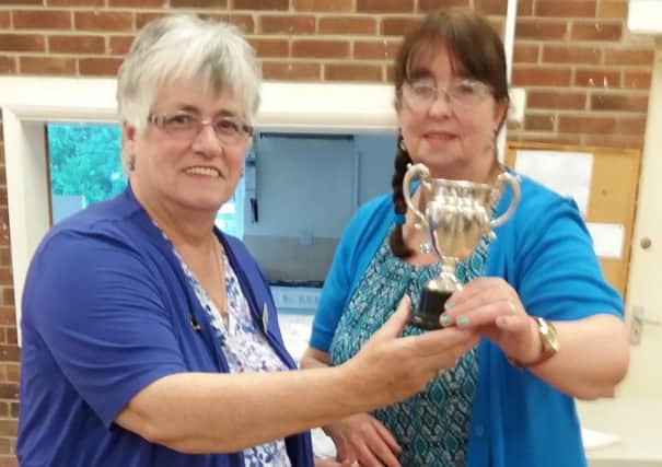 Norma Booth, WI Advisor, presenting the Kemp Cup for the most points in show to Keitha Eames. EMN-170713-155320001