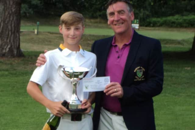 Proud dad and Men's Captain Gaff Elliott presents the coveted Harmsworth Trophy to his son Charlie - the youngest ever winner of the Championship.