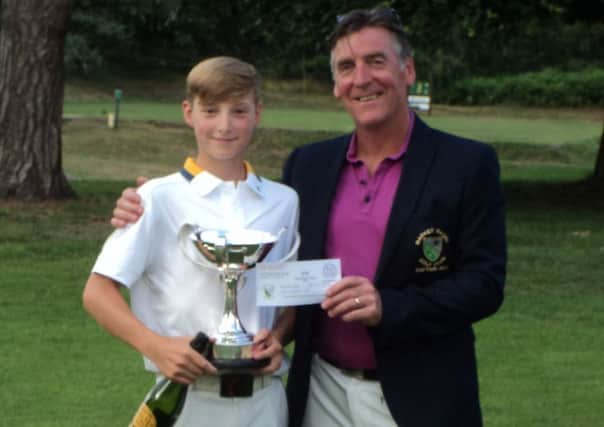 Proud dad and Men's Captain Gaff Elliott presents the coveted Harmsworth Trophy to his son Charlie - the youngest ever winner of the Championship.