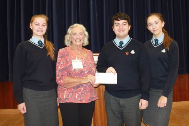 Students presented the cheque to Mrs Pat Wright.