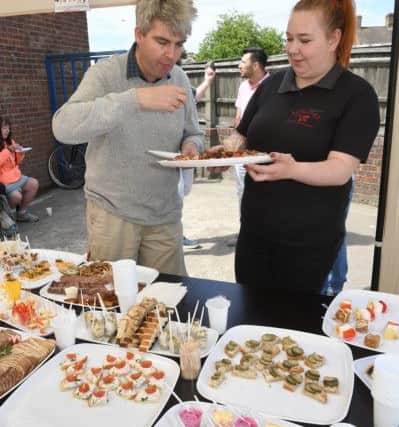 Korzinka open day. Christopher Dorrington of Boston trying food with shop assistant Kludia Wencel.