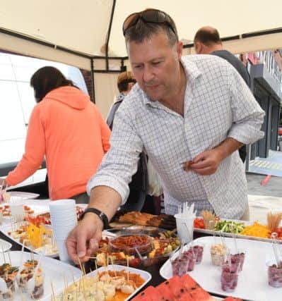 Korzinka open day. James Waller-Davies trying food.