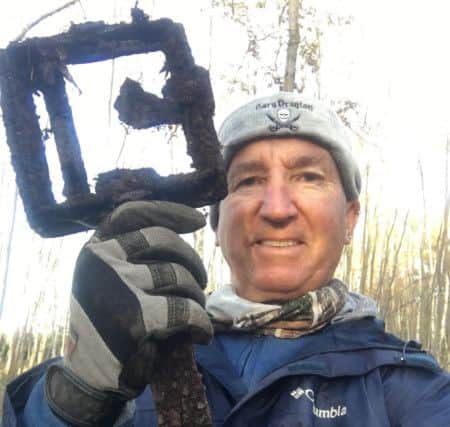 Gary Drayton with an old metal trap he found while searching at The Wash.