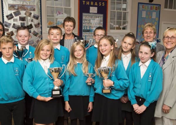 Theddlethorpe Academy Year 6 Awards.
(l-r) Jimmy Scholes, Jake Deeley, Ella Gray, Lewis Lack, Lacey Wright, Andrew Steele, Luci Farrand, Migle Vitkute, Angel Mahoney. 
Also pictured are (l-r) Teacher Jacqui Dale, Principal Mandy White, Teaching Assistant Marie Bishell and Vice Chair of Tollbar Board of Governors, Jane Aukett who presented the awards.
