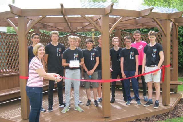 Headteacher Katie Gravil cuts the ribbon to the arbour seating area with the NCS team. EMN-170724-115753001