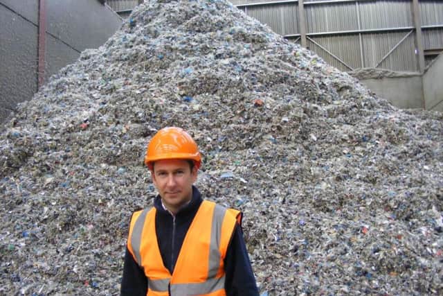Managing Director of Mid UK Recycling, Chris Mountain, with a heap of shredded textiles destined for recycling as fuel. EMN-170724-154804001