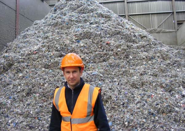 Managing Director of Mid UK Recycling, Chris Mountain, with a heap of shredded textiles destined for recycling as fuel. EMN-170724-154804001