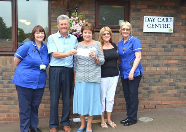 Organisers of the Motor Neurone Disease Charity Golf Day Paul Holloway (second from left) and Joan Kaye (second from right) are pictured presenting their donation to Senior Nurse Andrea Parker (left) and Senior Staff Nurse Christine Moore (right) of Lindsey Lodge Hospice and Motor Neurone Disease Associate Visitor Chris Dyer (centre). EMN-170724-165813001