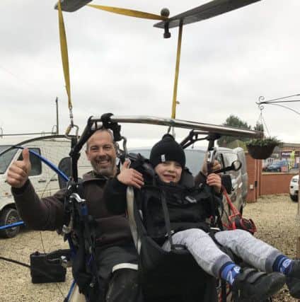 Lincolnshire Light Aircraft Festival's Brad Olson and his son Finley, six, in a paramotor.