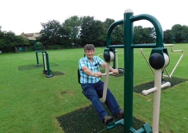 Heckington playing field steward Dave Couzens tries the leg press on the new outdoor gym equipment. EMN-170108-104217001