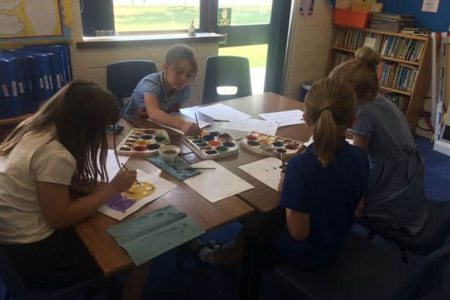 Pupils busy creating illustrations for the book. EMN-170725-121708001