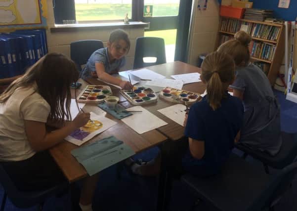 Pupils busy creating illustrations for the book. EMN-170725-121708001