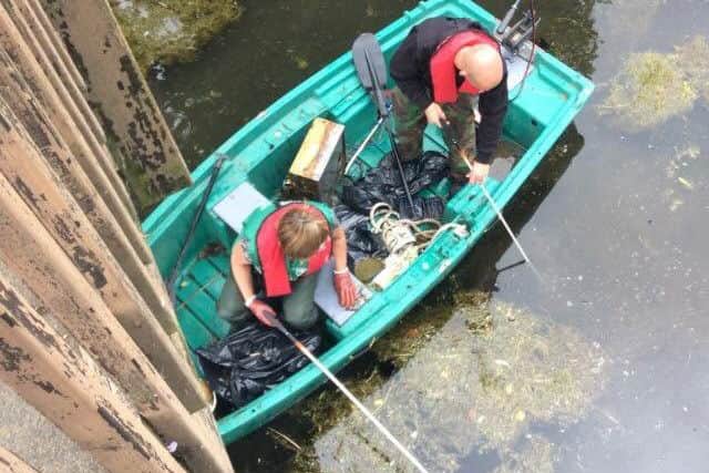 Fishing for litter on the River Slea. EMN-170725-125946001