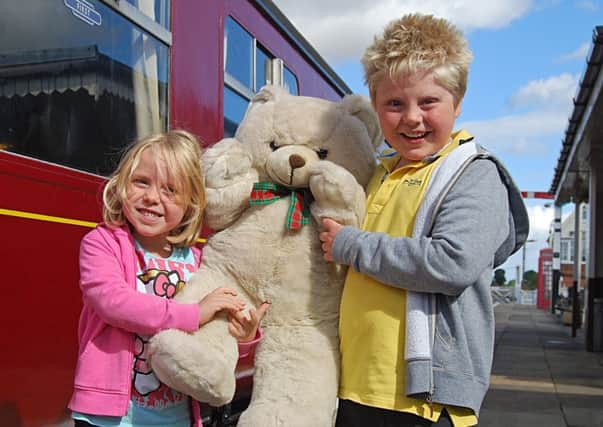 Louisa Clarke and her brother Josh with a giant cuddly bear at Ludborough station.